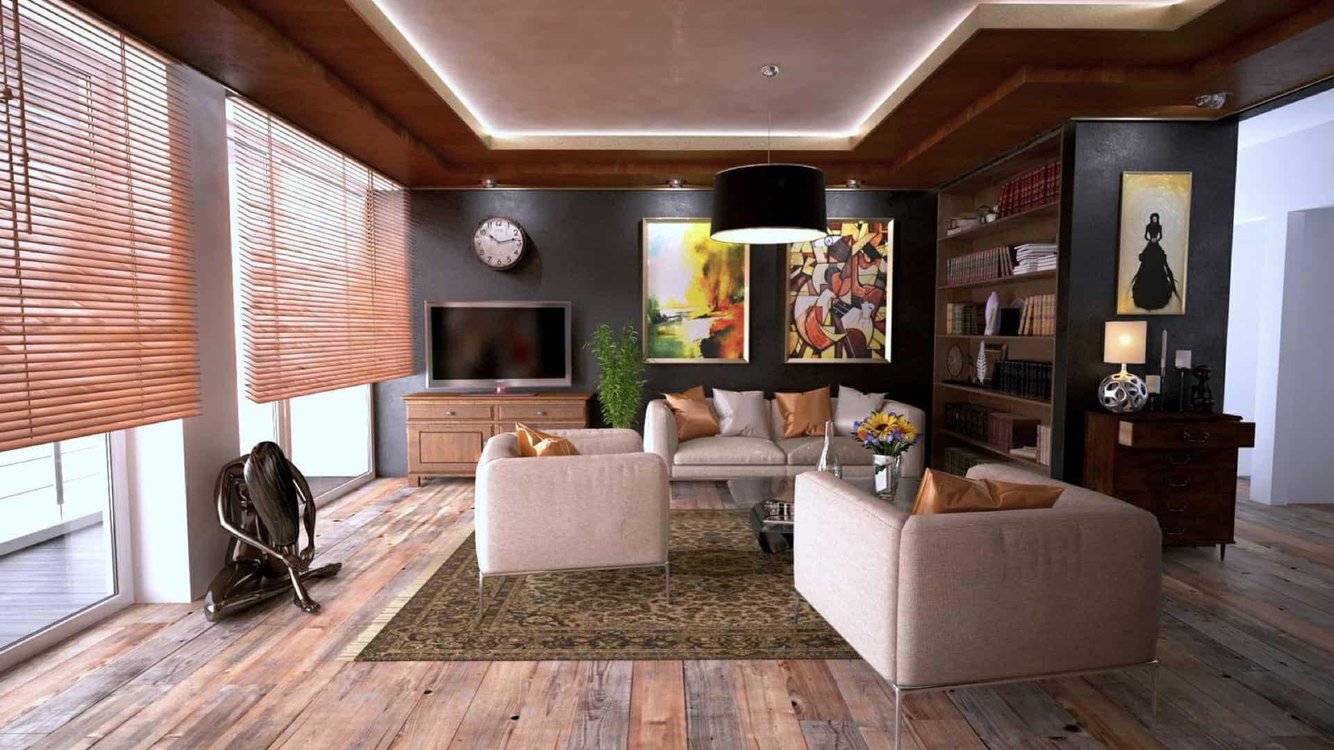 Open-plan living room with recessed cove ceiling lighting and wide-plank wood floors, interior finish work